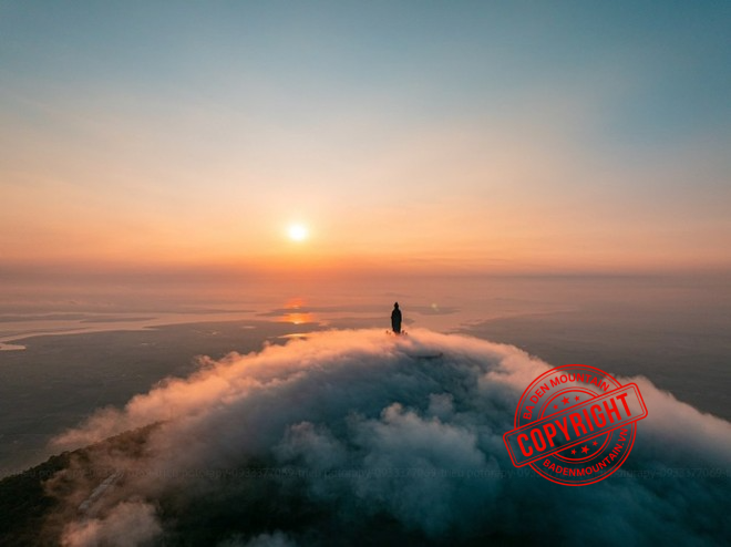 Panoramic view of the Lady Buddha statue on the peak of Ba Den Mountain surrounded by clouds. Ba Den Mountain Cable Car Ticket Prices 2026