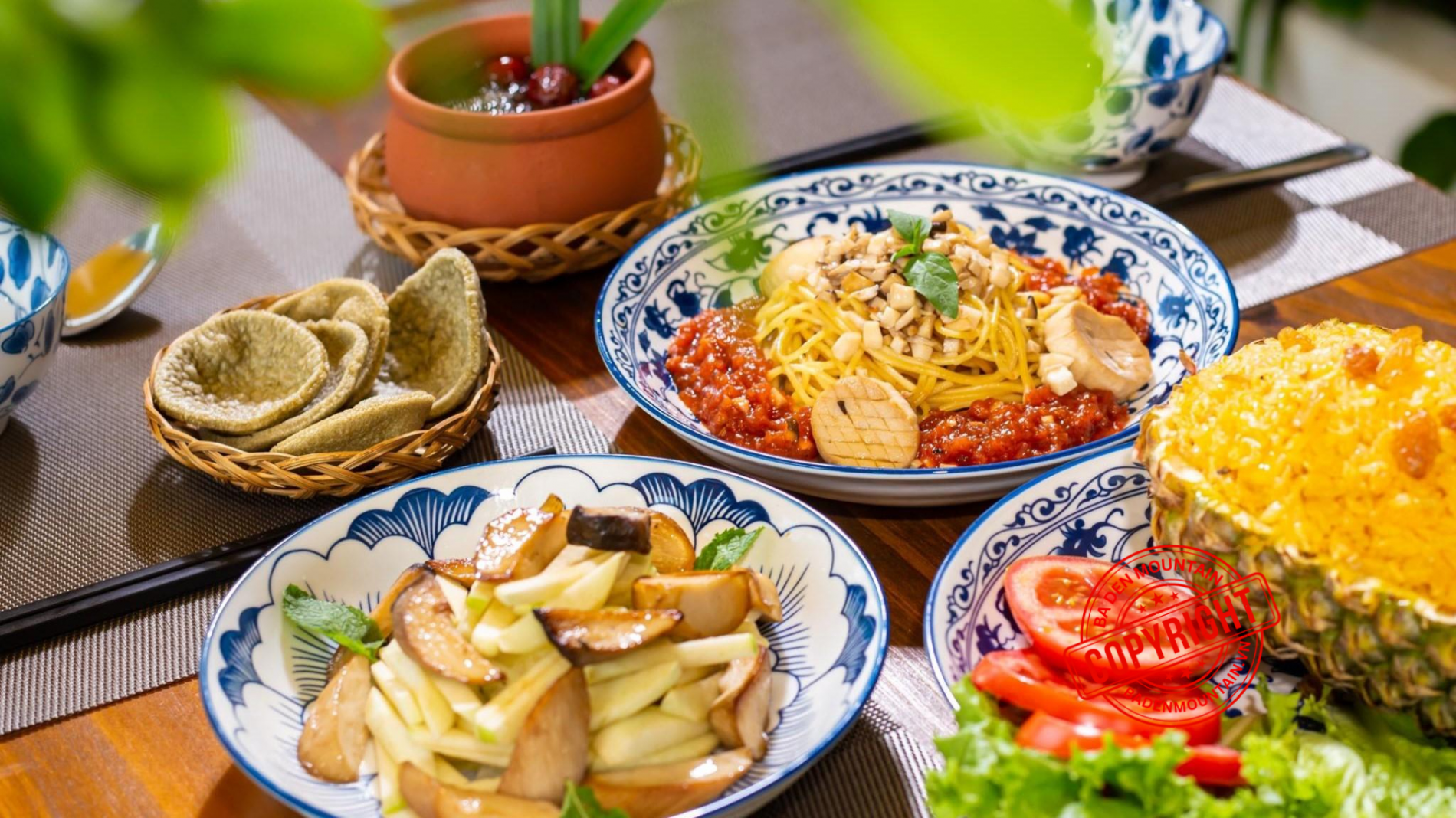 A delicious spread of traditional vegetarian dishes in Tay Ninh, including spring rolls and hot pot.