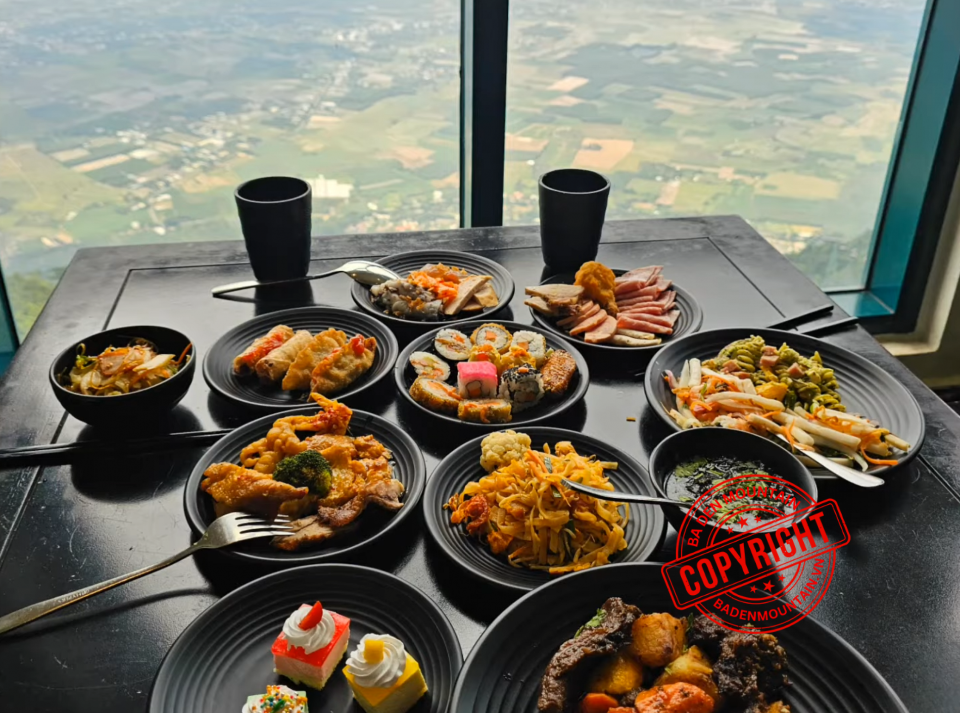 Tourists dining at Van Son Buffet on Ba Den Mountain peak with a view of the clouds.